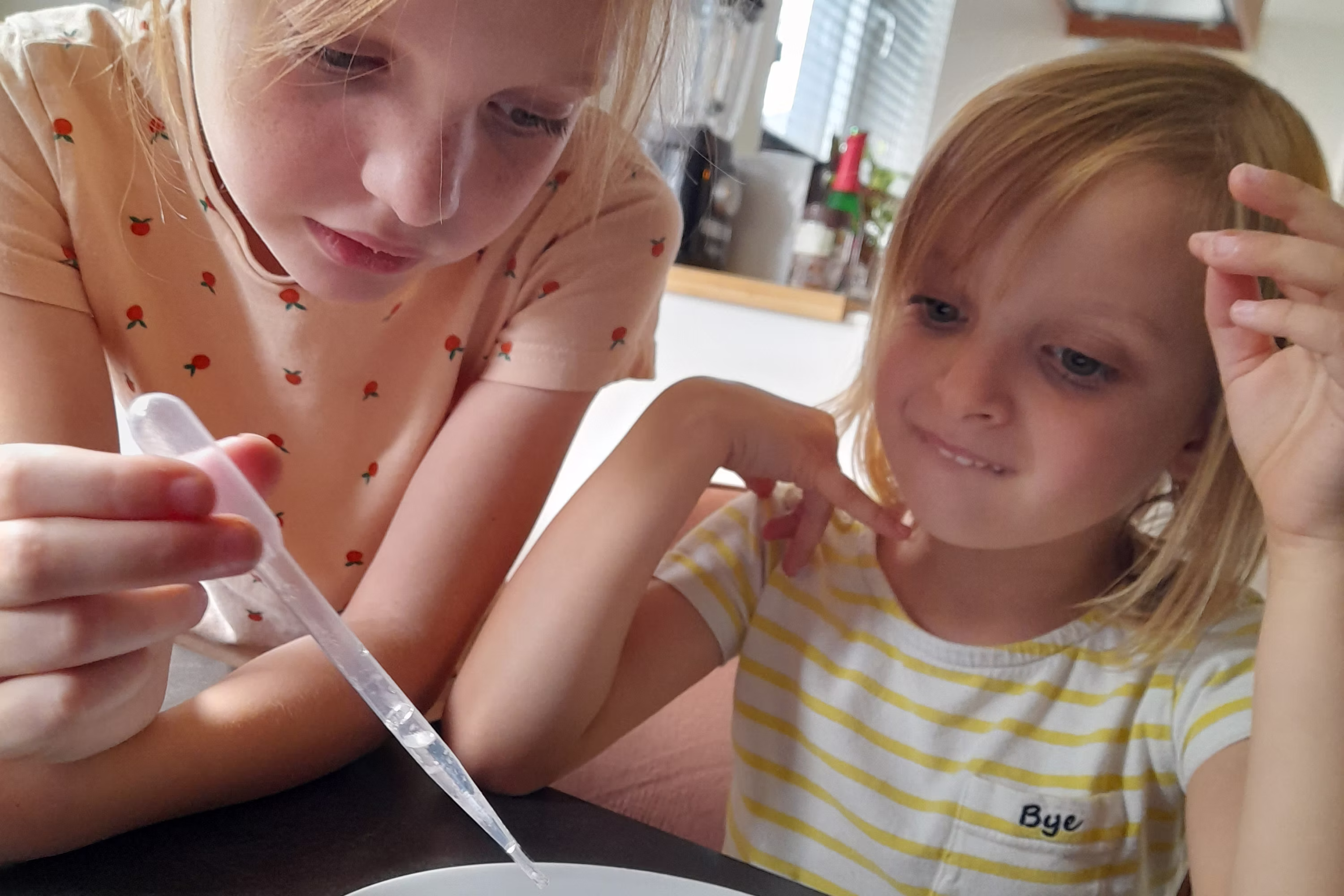 Kinderen verkleed als wetenschappers doen proefjes met snoep.